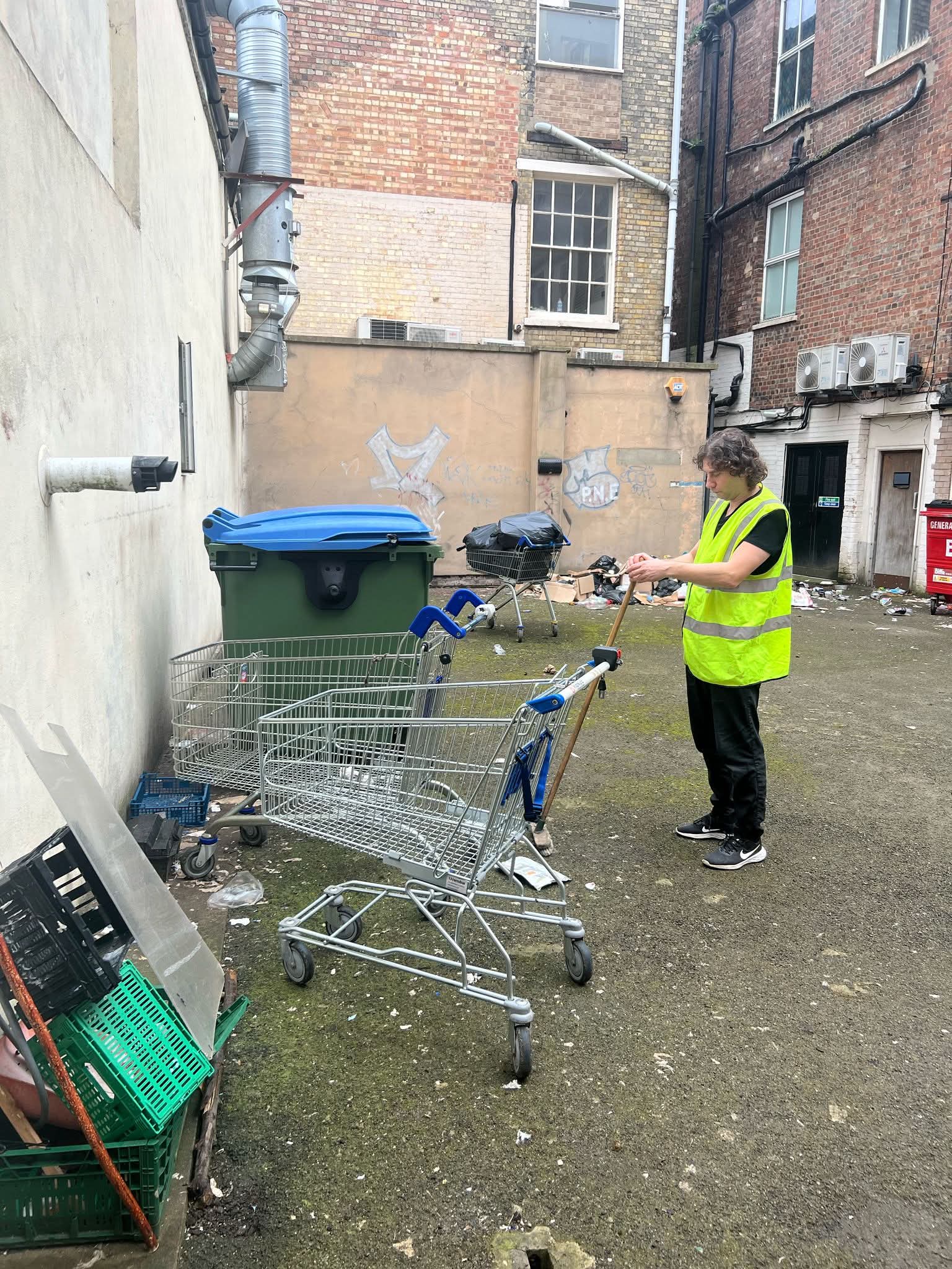 Preparing to sweep an outdoor business courtyard