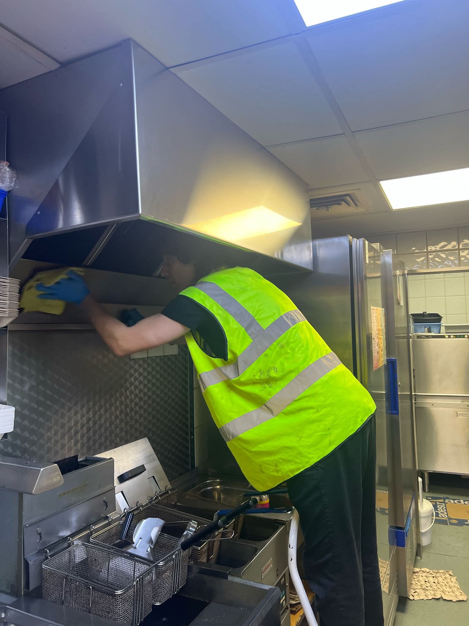 Wiping a commercial kitchen extractor hood